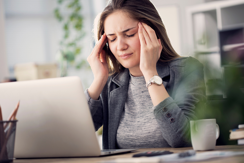 woman at computer with headache