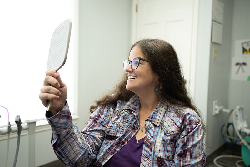 lady with smile reveal mirror