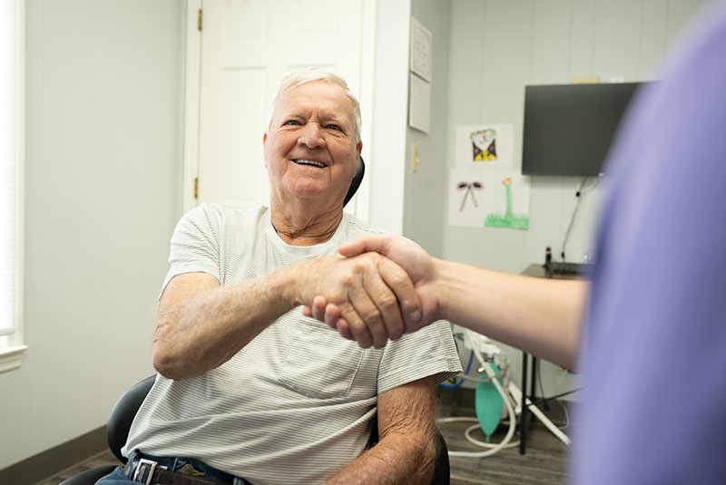 man listens to dr about dental plan